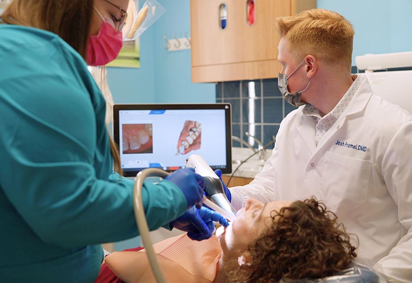 Dr. Fromel performing dental work on a patient in Cortland, OH